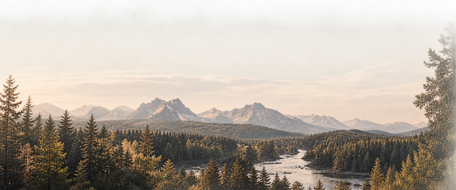 Wide alpine valley at sunrise, layered ridgelines.